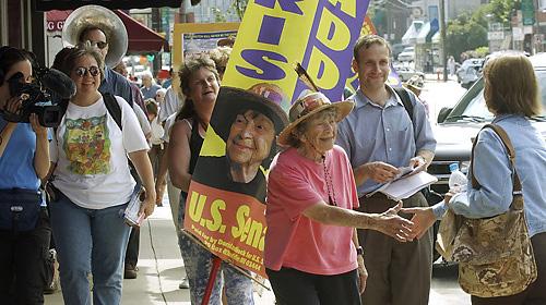 Marlo Poras, far left, films Democratic candidate for U.S. Senate, Doris "Granny D" Haddock as she marches down Main Street in Concord, N.H., on Sept. 15, 2004. Poras has produced a film on Haddock, "Run Granny Run," about her 2004 run for U.S. Senate, ai THE ASSOCIATED PRESS, JIM COLE
