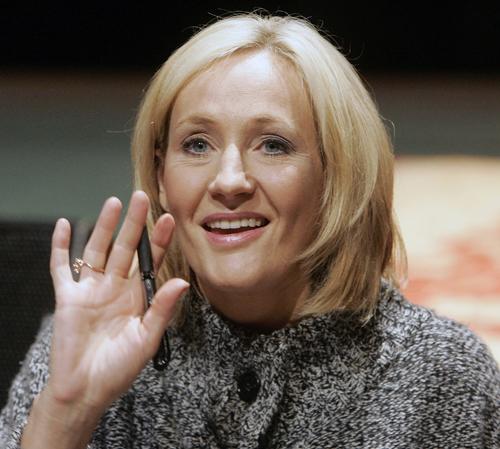 Author J. K. Rowling waves to children while signing a copy of her book "Harry Potter and the Deathly Hallows" in New Orleans, Thursday. Rowling, author of the mega-selling fantasy series, announced that the beloved character Albus Dumbledore, master wiza Bill Haber, The Associated Press
