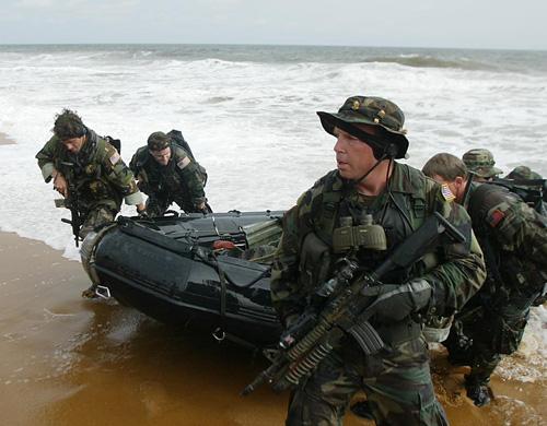 Navy Seals land on a beach in Monrovia, Liberia in this Aug. 18, 2003 file photo. The Pentagon is offering top commandos bigger salaries to encourage them to stay in service. THE ASSOCIATED PRESS, SCHALK VAN ZUYDAM
