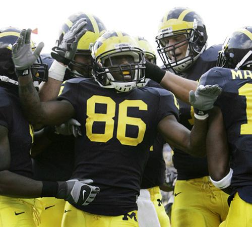 Michigan wide receiver Mario Manningham celebrates with teammates after scoring against Purdue in Ann Arbor, Mich., on Saturday. The Wolverines have clawed their way back into the AP Top 25 after an 0-2 start to their season. THE ASSOCIATED PRESS, PAUL SANCYA
