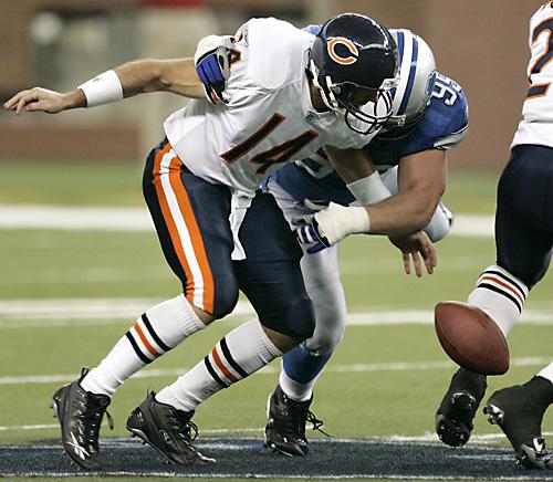 Chicago Bears quarterback Brian Griese fumbles while being sacked by Jared DeVries in the fourth quarter of a game in Detroit on Sunday. Detroit won 37-27. The Associated Press
