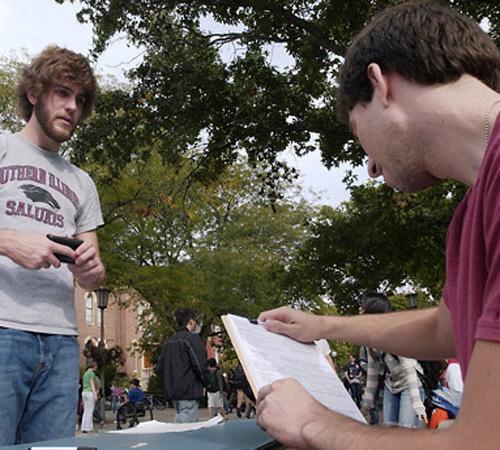 Ryan James, right, of College Democrats looks over a voter registration form with Jeff Dachauer, Freshman in LAS, outside the Union on Monday. Dachauer was already registered in his hometown, having voted in the 2006 elections, and decided to transfer his Erica Magda
