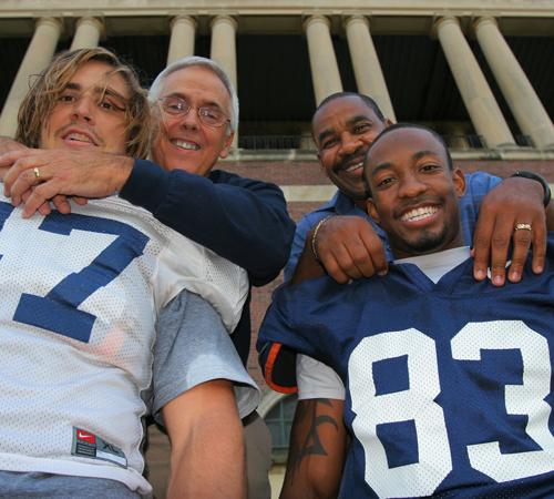 J Leman and his father, Happy, along with Jacob Willis and his father, Lenny, pose for a photograph in Memorial Stadium on Wednesday. Erica Magda
