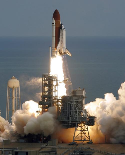 The space shuttle Discovery lifts off Tuesday at the Kennedy Space Center in Cape Canaveral, Fla. Erica Magda
