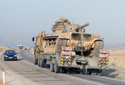 A Turkish army tank heads toward Sirnak at the Turkey-Iraq border in this Oct. 9 file photo. Laura Prusik
