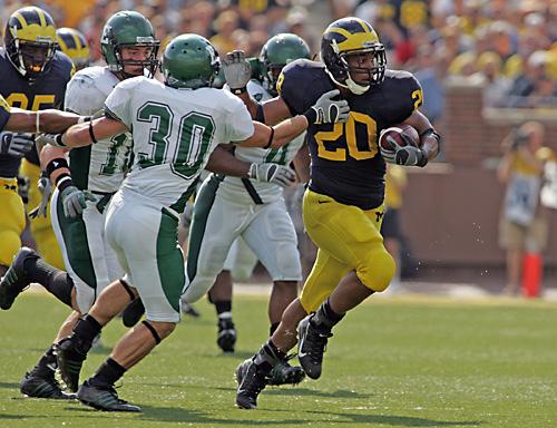 Michigan running back Mike Hart (20), runs past Eastern Michigan defensive back Lyle Garrison (30) to score a touchdown on Saturday in Ann Arbor, Mich. Michigan, after starting the season 0-2, is now undefeated in the Big Ten. THE ASSOCIATED PRESS, TONY DING
