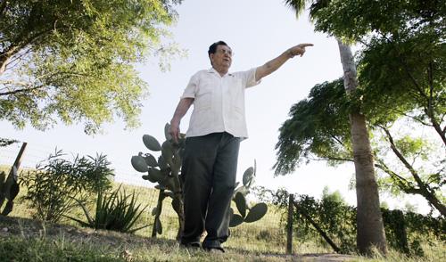 Daniel Garza, 74, talks about a proposed border wall from his backyard in Granjeno, Texas, Wednesday. A proposed border fence could cut through property of about 35 homes in the city along the border. The Associated Press, Eric Gay
