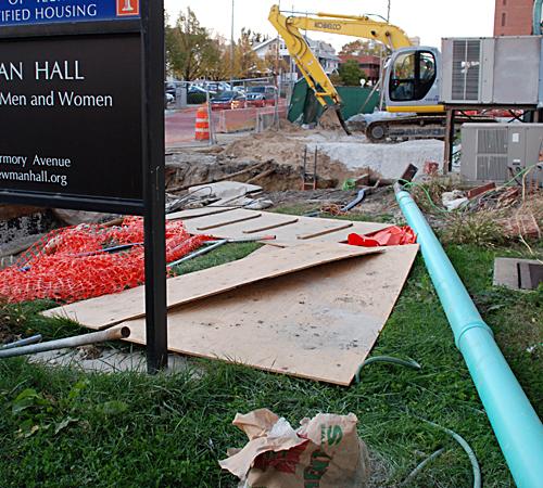 Construction material for the addition being built onto the existing building surround the Newman Hall sign Sunday. Erica Magda
