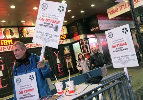 Striking stagehand John Senter, left, pickets in front of the Palace Theatre, Monday in New York. Negotiations continued Monday evening between the American League of Producers and the Local 1 Stagehands Union in an attempt to end a strike that has shut d Gary He, The Associted Press
