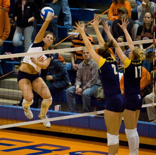Sophomore outside hitter Kylie McCulley spikes the ball past Michigan at Huff Hall on Saturday. Illinois is back on the road next weekend. Laura Prusik

