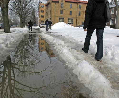 Students struggle with snow that covers sidewalks in this Feb. 20 file photo. Erica Magda
