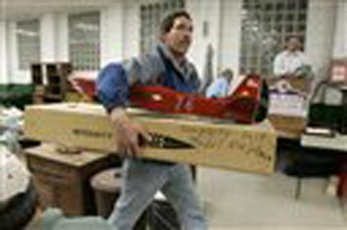 Dave Kauffman, who traveled 220 miles from Marysville, Ohio, in search of vintage, remote-control model airplanes takes one of five loads of purchases to his car during an auction Nov. 2, 2007 in Waynesburg, Pa. Kauffman, 49, has trolled the Internet for Gene J. Puskar, The Associated Press
