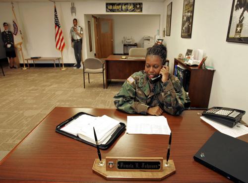 Sgt. 1st Class Pamela Johnson works the phone at the Army recruiting office in Waterloo, Iowa, in this July 7, 2005 file photo. Erica Magda
