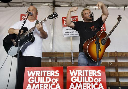 Satirical rock band Tenacious D composed of musician/actors Kyle Gass, left, and Jack Black perform for the striking Writers Guild of America union members as they picket in front of FremantelMedia, in Burbank, Calif., Friday. Striking Hollywood writers Kevork Djansezian, The Associated Press
