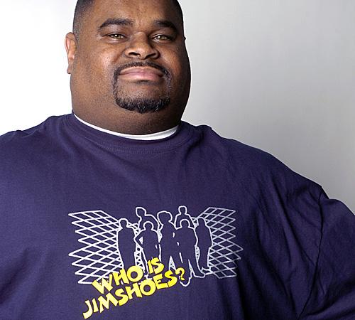 James Hastings, Urbana resident and founder of Jimshoes Entertainment, poses in a shirt from his clothing line. Erica Magda
