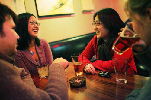 Jennifer Kim, second from right, laughs with friend Karla Melendez, second from left, both graduate students, at Cowboy Monkey on Friday night with friends Sara Beal, right, alumnus, and Andreas Ehmann, left, also a graduate student. Beth Gilomen
