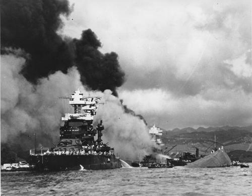 Torpedoed and bombed by the Japanese, the battleship USS West Virginia begins to sink, center, while the USS Maryland, left, is still afloat in Pearl Harbor, Oahu, Hawaii, in a Dec. 7, 1941 file photo. The capsized USS Oklahoma is at right. This year ma The Associated Press
