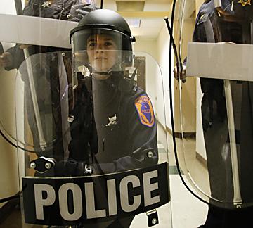 The University of Illinois police demonstrate use of riot shields at their campus facility, Monday. Erica Magda
