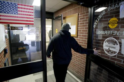 Marine veteran of the Iraq war Mike Lally walks through the main entrance of a veterans homeless shelter, in Leeds, Mass., on Wednesday, Dec. 5, 2007. Lally did two tours of duty in Iraq while serving with the Marine Corps. Steven Senne, The Associated Press
