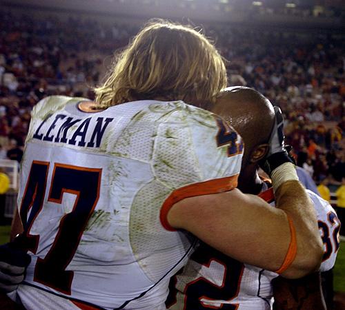 J Leman and Justin Harrison embrace after the Rose Bowl, their final game as Illini, in Pasadena, Calif., on Jan. 1. Illinois lost to the USC Trojans 49-17. Erica Magda
