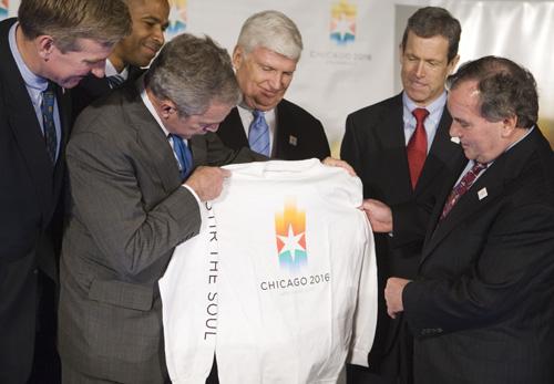 President Bush holds a Chicago 2016 Olympics shirt presented to him by Chicago Mayor Richard M. Daley, right, and Patrick Ryan, center rear, after meeting with the Chicago 2016 Bid Committee and U.S. Olympic Committee members at the Union League Club of C Haraz N. Ghanbari, The Associated Press
