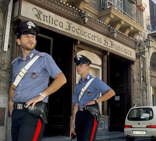 Police guard the Antica Focacceria San Francesco sandwich restaurant in downtown Palermo, Sicily, southern Italy, in this Oct. 5 photo. In a rebellion shaking the Sicilian Mafia to its centuries-old roots, businesses in growing numbers are refusing to sub Alessandro Fucarini, The Associated Press

