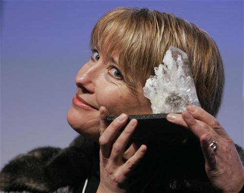 British actress Emma Thompson reacts holding the Crystal award at the World Economic Forum in Davos, Switzerland, Friday Jan. 25, 2008. The Crystal award is presented to artists who use their art to reach out to other cultures. Peter Dejong, The Associated Press
