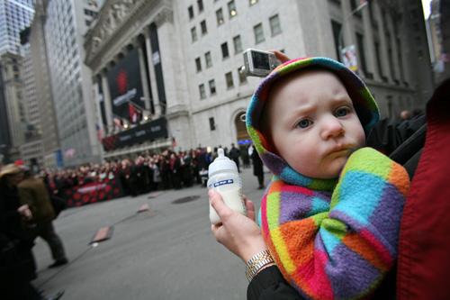 Ellen Wright, 1, is held by her father as they visit Wall Street and the New York Stock Exchange on Tuesday. Wall Street was mixed in early trading Tuesday as the Federal Reserve opened a two-day meeting expected to result in another interest rate cut. Mark Lennihan, The Associated Press
