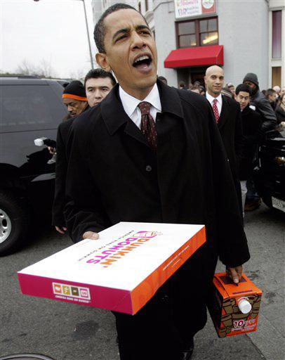 Democratic presidential hopeful, Sen. Barack Obama, D-Ill., followed by Washington Mayor Adrian Fenty, right, and others, offers coffee to his volunteers who have come out to get out the vote, Tuesday, Feb. 12, 2008, in Washington. Rick Bowmer, The Associated Press
