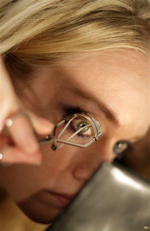 A model works on her eyelashes before the Miss Sixty fall fashion show during Fashion Week in New York, Sunday, Feb. 3. Seth Wenig, The Associated Press
