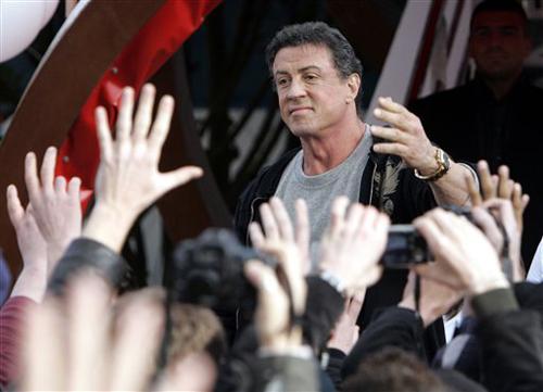 Actor Sylvester Stallone waves to fans at the Planet Hollywood restaurant in Disneyland Paris on Saturday. Stallone is in Paris to promote his latest film, quot;&Rambo.quot;& Remy de la Mauviniere, The Associated Press
