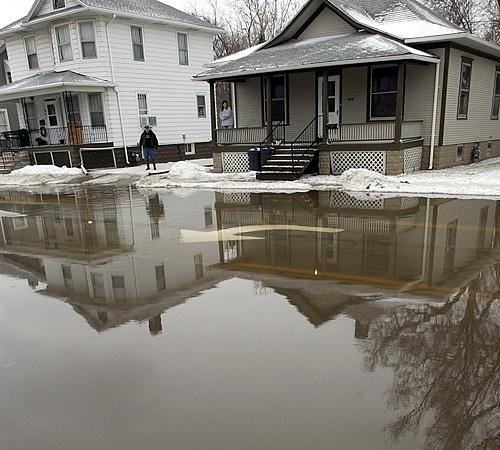 Homeowners along Route 24 watch as flood waters rise in Watseka, Ill., Thursday. Nicholas Holstein, The Associated Press
