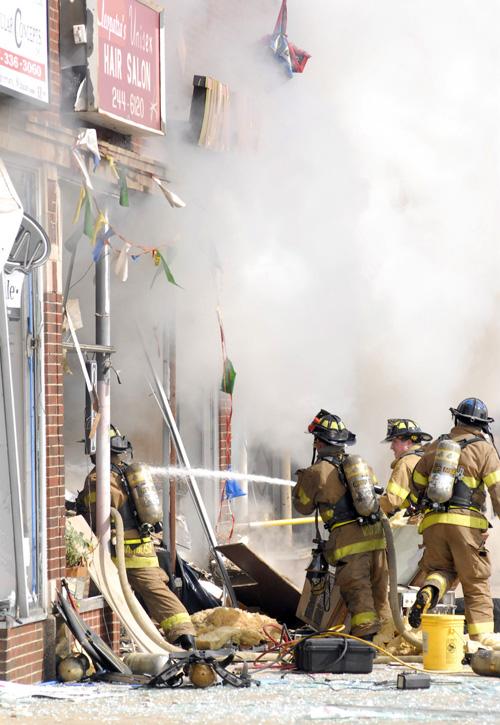 Area+firefighters+and+paramedics+including+Waukegan+Fire+Chief+Patrick+Gallagher%2C+right%2C+take+away+an+injured+woman+from+the+scene+of+an+apparent+gas+explosion+at+a+hair+salon+in+Waukegan%2C+Ill.%2C+just+after+noon+Thursday.+Laura+Weisman%2C+The+Associated+Press%0A