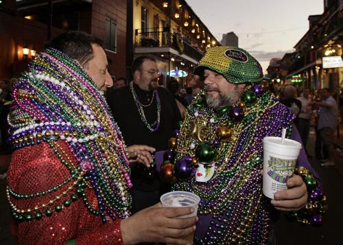 Jerry Kummel (left) from New Orleans and Chas Boeck from Haines City, Fla., stand covered in beads for the celebration in New Orleans, Monday. Alex Brandon, The Associated Press
