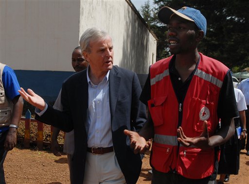 U.N. Under Secretary General for Humanitarian Affairs and Emergency Relief Coordinator John Holmes, left, listens to a Kenyan Red Cross team leader while visiting the grounds of a police station in Tigoni, Kenya, Sunday, Feb. 10, 2008. The police station Walter Astrada, The Associated Press
