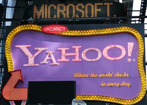 A Times Square news ticker flashes a headline about Microsoft above a billboard for Yahoo! in New York in this Friday, May 4, 2007 file photo. Microsoft Corp. has pounced on slumping Internet icon Yahoo Inc. on Friday, Feb. 1, 2008, with an unsolicited ta Pamela Nisivaco
