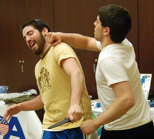With his roommate, Matt Levee a junior in philosophy and sociology and Noam Davidoff a junior in community health, practice Krav Maga moves on each other. The class was held at the Hillel Foundation Wednesday night. Ally Schlumpf
