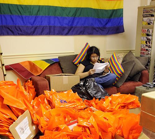 Shauntel Reed, freshman in LAS, studies on a couch in the Office of LGBT Resources inside the Illini Union, Thursday. The office was filled with boxes of supplies in preparation for the Midwest Bisexual Lesbian Gay Transgender Ally College Conference to b Erica Magda
