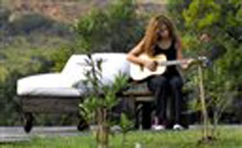 Colombian singer Shakira plays guitar at her rural estate, known as La Colorada, in Maldonado, Uruguay, Saturday, Feb. 9, 2008. Ricardo Figueredo, The Associated Press
