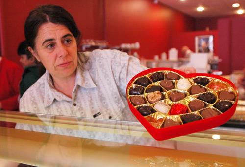 Marleen Hendrickx works on a Valen Chocolate in Champaign, Tuesday. The shop has been making its own gourmet chocolates and truffles for 27 years, starting in Danville. Erica Magda
