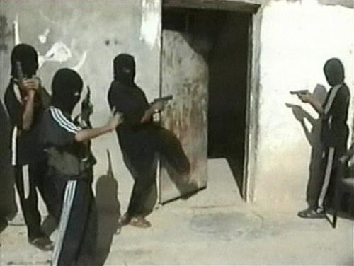 This undated image made from video released by the US military in Iraq which it says shows an apparent al-Qaida training operation. The videotapes seized during U.S. raids on suspected al-Qaida in Iraq hide-outs show the terror group training young boys t AP Photo/US Military via APTN
