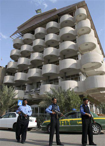 Iraqi policemen stand guard in front of the Sultan Palace Hotel in central Basra, Iraq, Tuesday, Feb. 12, 2008. The U.S. television network CBS reported Monday that two of its journalists had gone missing in the predominantly Shiite southern city of Basra Nabil al-Jurani, The Associated Press
