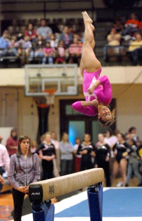 Freshman Melissa Fernandez flips off the balance beam Saturday, at Huff Hall. Erica Magda
