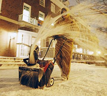 ob Shaw, a buildings and services employee from Urbana, clears snow away from the steps of the Union on the Quad side Thursday evening. Check DailyIllini.com throughout the day for weather updates. Erica Magda
