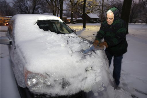 Jeff Cavalcante removes snow and ice from his car in the Hikes Point area of Louisville, KY., Tuesday, Feb. 12, 2008. Michael Clevenger, The Courier-Journal
