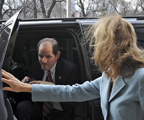 New York Gov. Eliot Spitzer arrives with his wife at his New York City apartment Monday. Spitzer, who built his career on rooting out corruption, apologized after he was accused of involvement in a prostitution ring. Louis Lanzano, The Associated Press
