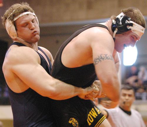 John Wise competes against an Iowa wrestler on Feb. 24 at Huff Hall. Illinois lost 12-21. Erica Magda
