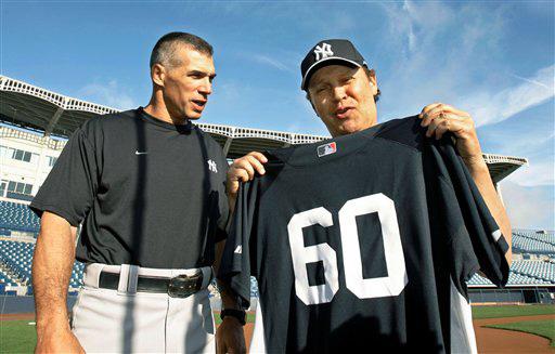 New York Yankees manager Joe Girardi, left, poses with actor and comedian Billy Crystal after Crystal signed with the Yankees for a workout and one game against the Pittsburgh Pirates at spring training baseball at Legends Field in Tampa, Fla., Wednesday, Kathy Willens, The Associated Press
