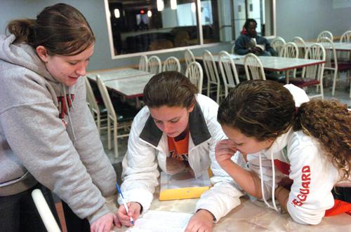 Freshmen Stephanie Franz, Megan Reily, and Kim Chamales develop a game plan during the Hunt for Heart photo scavenger hunt, Saturday. The event raised money for the American Heart Association. Katie Lafferty
