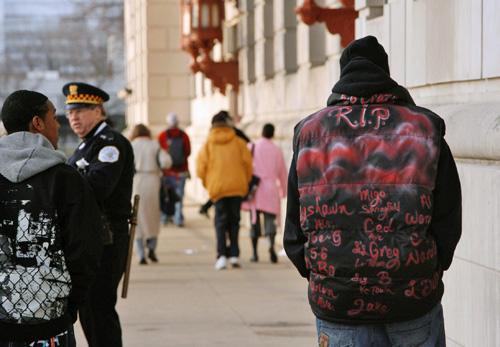 A Crane Tech High School student wears a jacket with a list of names of people who have died as he heads into school Monday in Chicago. Following the slaying of a student this month, community leaders, parents and police gathered for Operation Safe Passa Nancy Stone, The Associated Press
